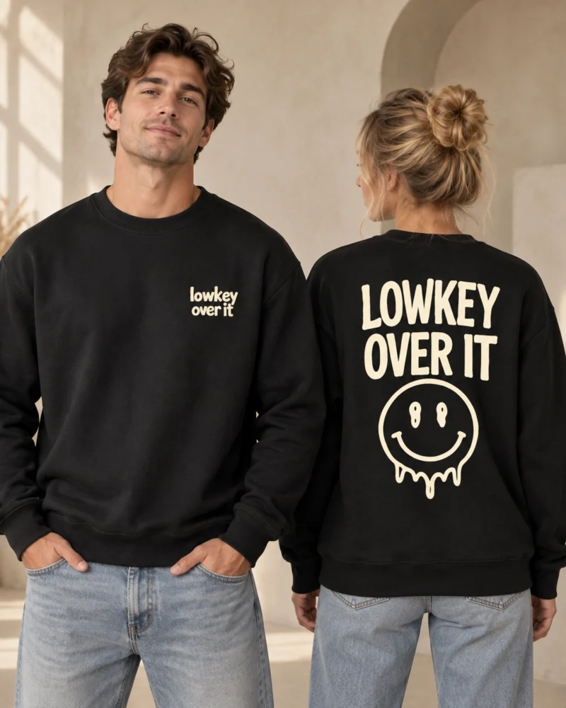 Lowkey Over It unisex relaxed-fit black crewneck sweatshirt, front and back view